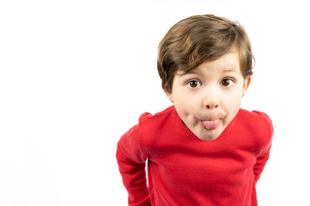 istock Little boy sticking out his tongue, white background 1369008969