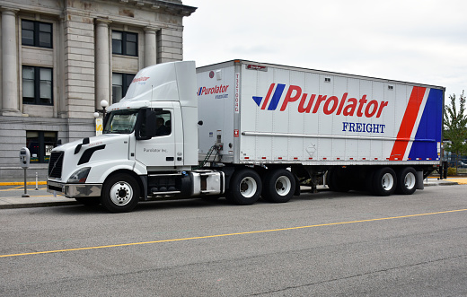 Building Exterior, Purolator Freight Long Haul Truck On The Road Scene During The Day In Vancouver City British Columbia Canada