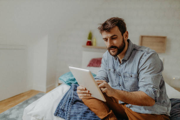 istock Young man in the bedroom 1369009565