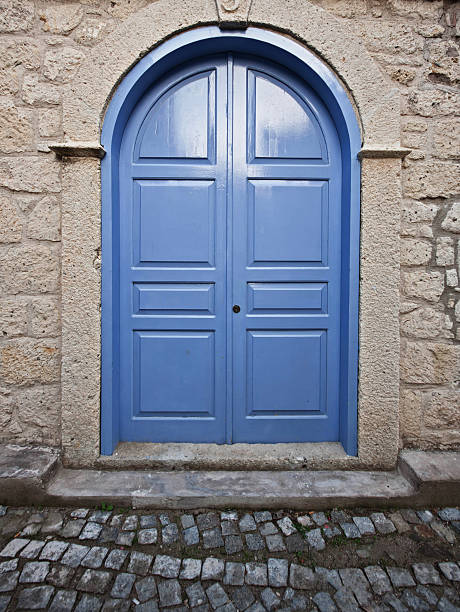 Wooden Blue Door Wooden door of ancient building. blue front door stock pictures, royalty-free photos & images