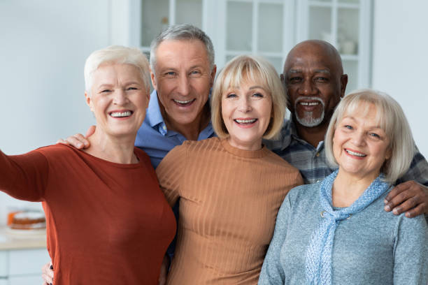 istock Positive senior people taking selfie together, kitchen interior 1369013065