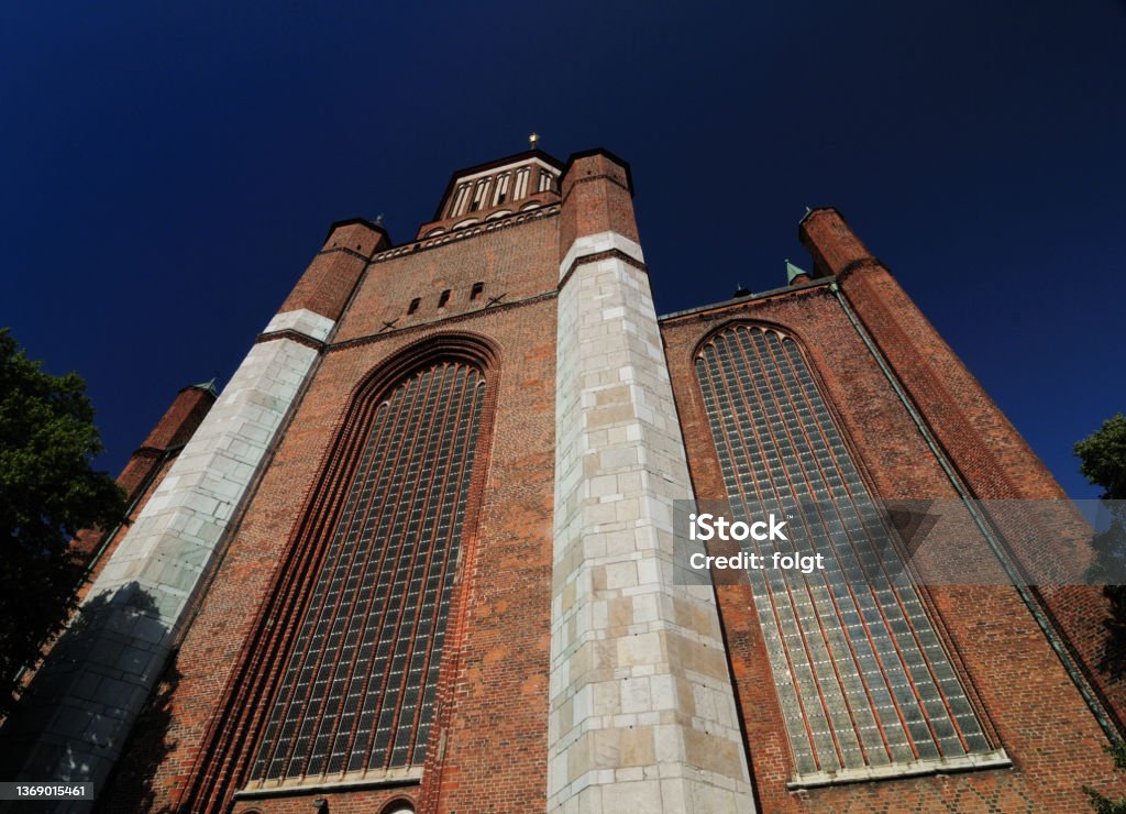 Bottom Up View To The Bell Tower Of The Gothic Basilica Marienkirche In Stralsund Germany On A Beautiful Sunny Summer Day Bottom Up View To The Bell Tower Of The Gothic Basilica Marienkirche In Stralsund Germany On A Beautiful Sunny Summer Day With A Clear Blue Sky Cultures Stock Photo