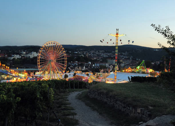 view from the vineyard hill michelberg to the famous wine festival wurstmarkt in bad duerkheim germany on a beautiful sunny summer evening - carnival amusement park amusement park ride traditional festival imagens e fotografias de stock