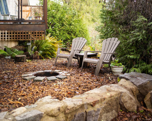 istock Deck chairs and a fire pit outside of a cabin 1369015685