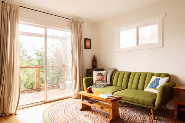 istock Living room with doors leading out to a patio with a view 1369015908