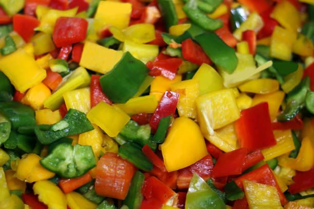 Colored and sliced bell peppers. Abstract food background.