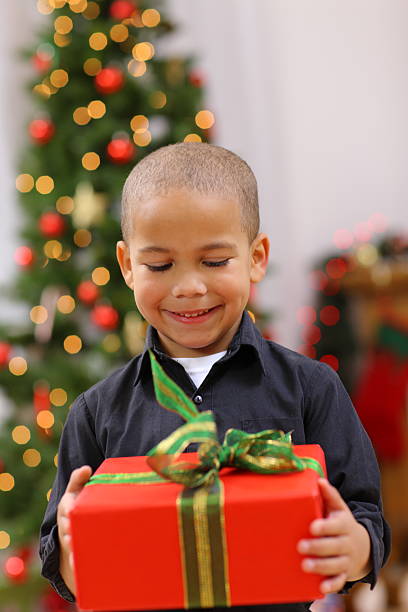 istock Young boy looking at Christmas gift 136901676