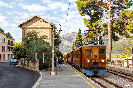 Bunyola, Spain - October 21, 2021: Ancient train Tren de Soller public transport transit transportation at Bunyola railway station on Mallorca in Spain.