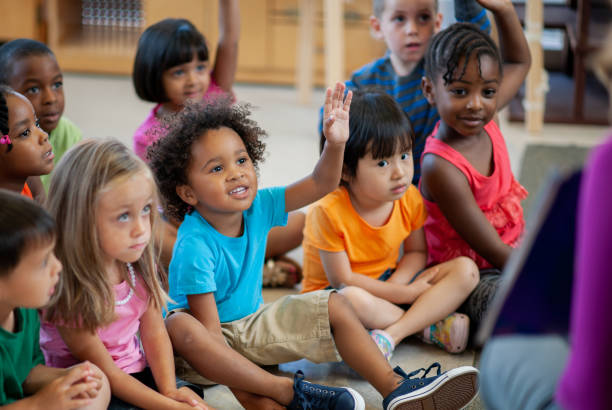istock Daycare Teacher Reading to Students 1369017704