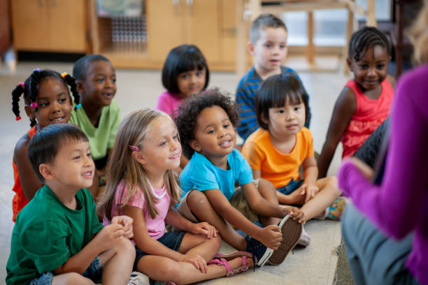 istock Daycare Teacher Reading to Students 1369017706