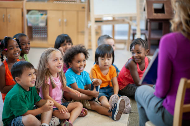 istock Daycare Teacher Reading to Students 1369017709