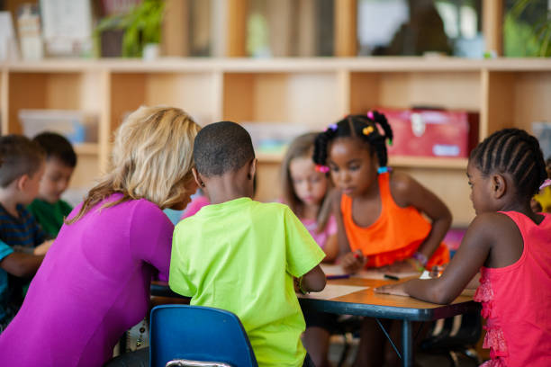 istock Teacher Working with Daycare Children 1369017712