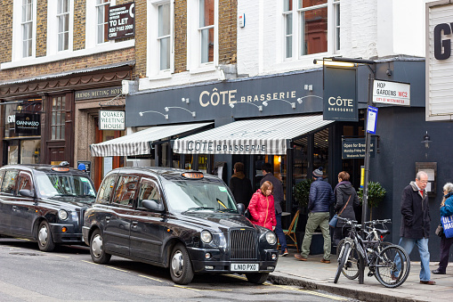 People walking past Côte Brasserie on St Martin's Lane in City of Westminster, London