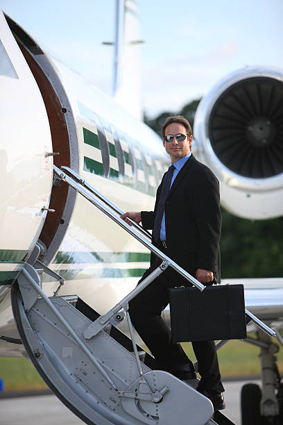 istock Businessman standing on stairs to private jet 136901778