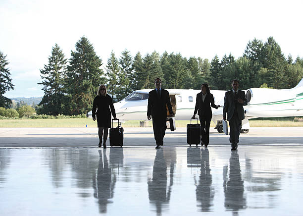 istock Businesspeople walking by corporate jet 136901808