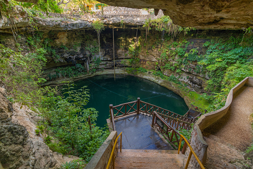 Cenotes Dzitnup is a complex of underground cenotes only 40 minutes away from Valladolid. One of the two cenotes you will find here, Xexhen, is a huge underground cave with some natural light coming through. The second cenote, Sumala, is smaller but it has three shades of colours in the water, from light crystal blue, to green to very dark blue, which can clearly be seen from outside.