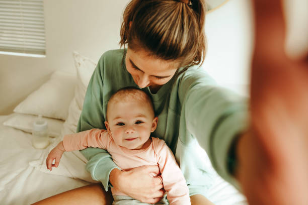 istock Millennial mom taking a selfie with her adorable baby 1369019783