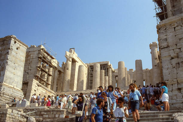 Athens, Greece - aug 05, 1987: crowds of tourists ascend to the Propylaea, the monumental entrance to the esplanade of the Acropolis where the Parthenon is located