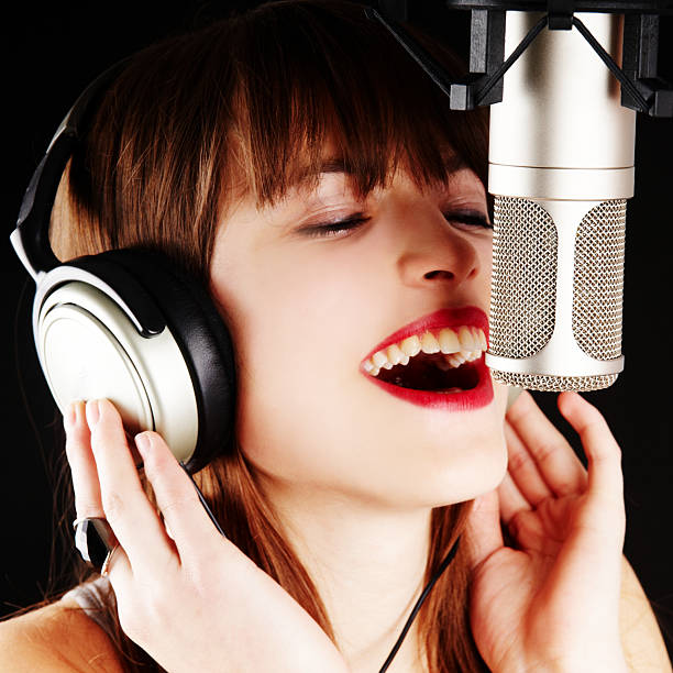 istock girl singing to the microphone in a studio 136902190