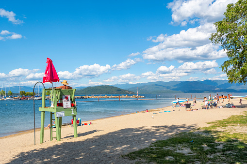 A female lifeguard on duty watches over sunbathers and swimmers in Lake Pend Oreille, in the Bonner County small town of Sandpoint, Idaho.