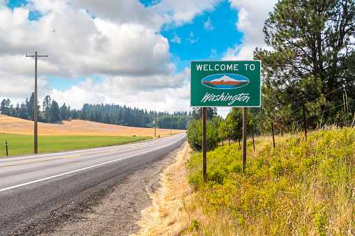 A roadside welcome to Washington State sign in the rural Palouse area near Spokane, Washington, USA.