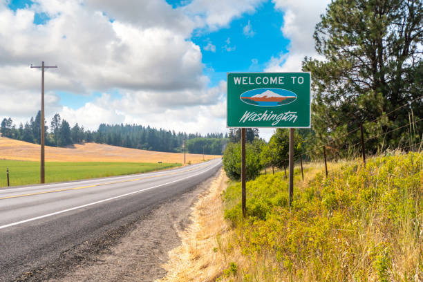 A roadside welcome to Washington State sign in the rural Palouse area near Spokane, Washington, USA. A roadside welcome to Washington State sign in the rural Palouse area near Spokane, Washington, USA. whitman county washington state stock pictures, royalty-free photos & images