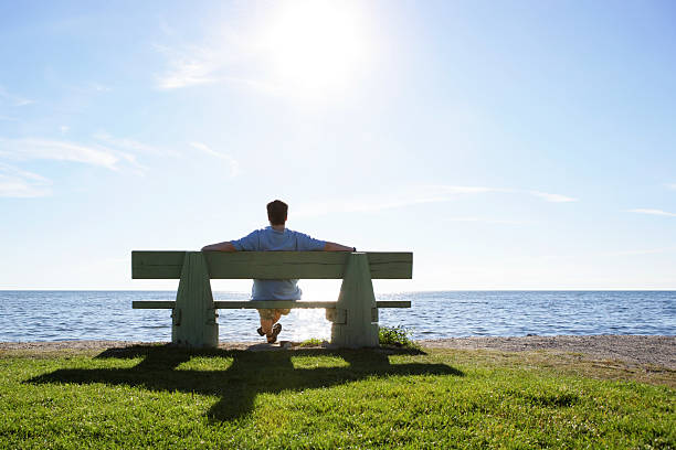 istock XL man on park bench overlooking ocean 136902453