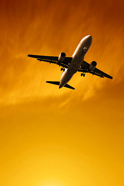 istock jet airplane landing at sunset 136902458