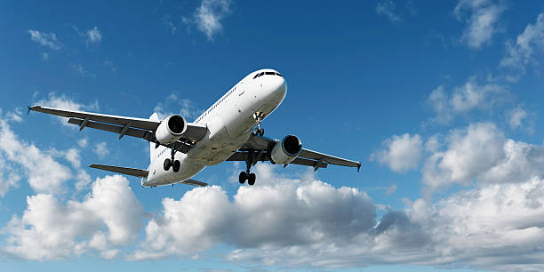 istock XL jet airplane landing in bright sky 136902481