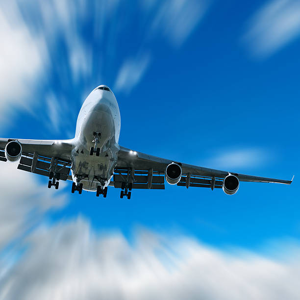 istock jumbo jet airplane landing in motion blur sky 136902488