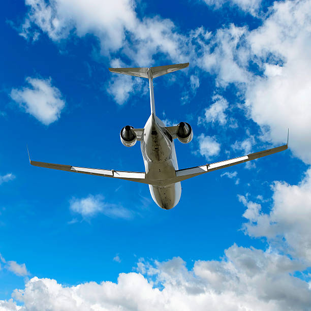 istock XL corporate jet airplane landing in bright sky 136902655