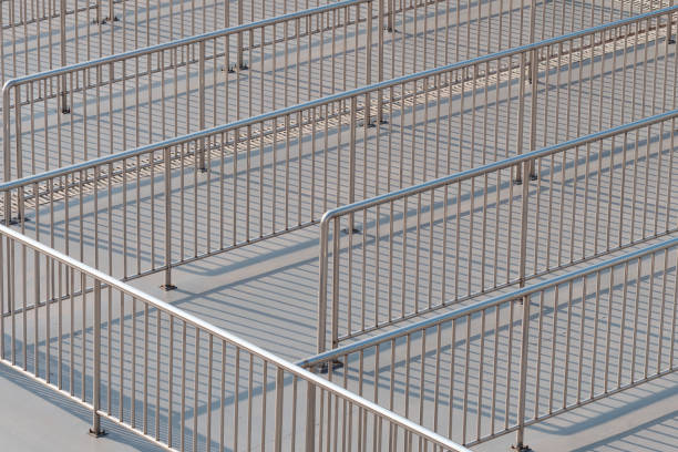 Fence for queuing in sun light on square. stock photo