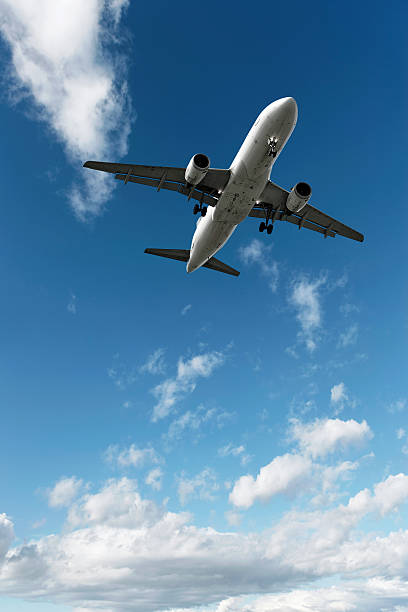 jet airplane landing in bright sky
