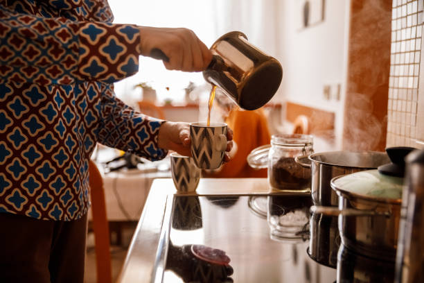 istock Woman pouring freshly brewed coffee into a cup 1369027104