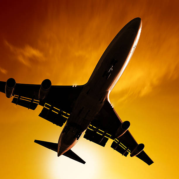 istock XL jumbo jet airplane landing at sunset 136902749