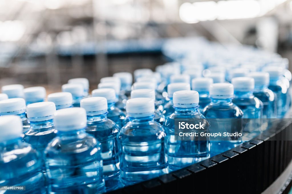 Bottling plant Bottling plant - Water bottling line for processing and bottling carbonated water into bottles. Bottle Stock Photo