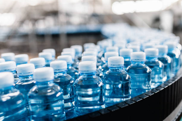 Bottling plant Bottling plant - Water bottling line for processing and bottling carbonated water into bottles. plastic drink bottle stock pictures, royalty-free photos & images