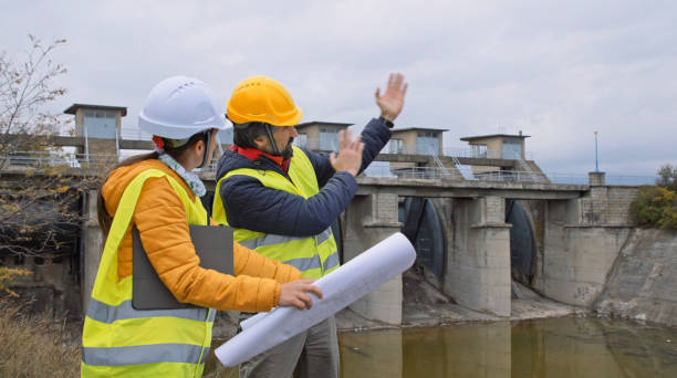 istock Maintenance engineers working in hydroelectric dam. Ecology orientated. Renewable energy systems. 1369028190