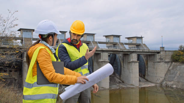 istock Maintenance engineers working in hydroelectric dam. Ecology orientated. Renewable energy systems. 1369028193