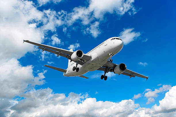 istock XL jet airplane landing in bright sky 136902835