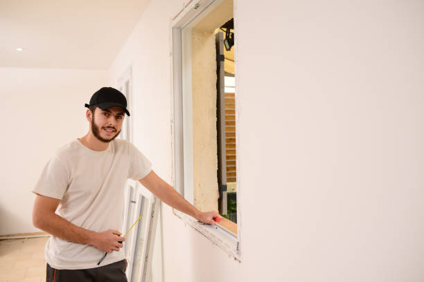 istock handsome young professional man installing and replacing a new home windows in client house for improvement energy saving efficiency isolation 1369028369
