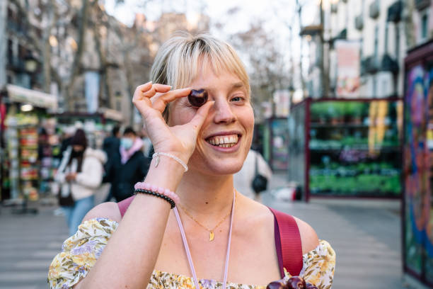 istock Happy woman covering eye with cherry 1369028392