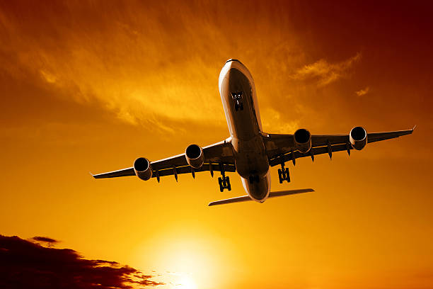 istock jet airplane landing at sunset 136902840