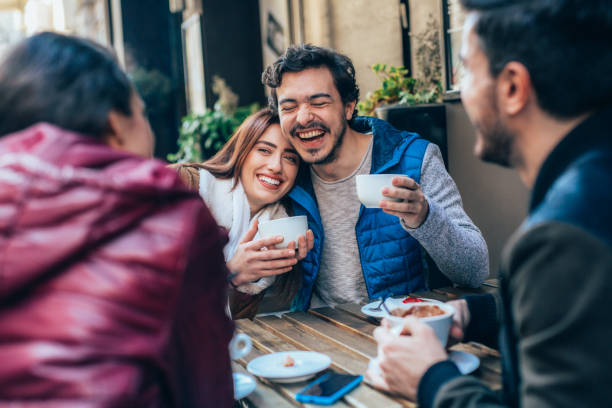 istock Friends talking and laughing in a cafe 1369031055