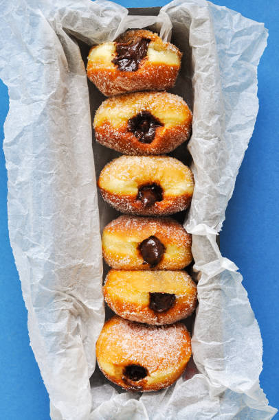 istock Homemade sugary doughnuts or berliners with chocolate filling. 1369031224
