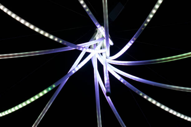 White glowing sticks on black background. Long fluorescent lights in chaotic pattern