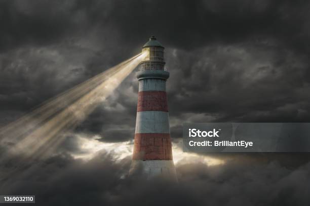 3d Rendering Of An Illuminated Lighthouse Over Fluffy Clouds And Dark Sky Stock Photo - Download Image Now