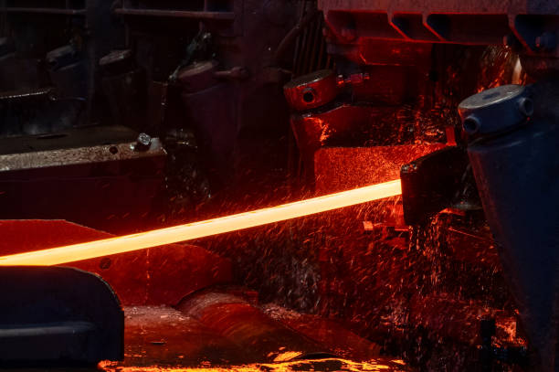 istock Red-hot metal billet on the roller table of a rolling mill 1369032125