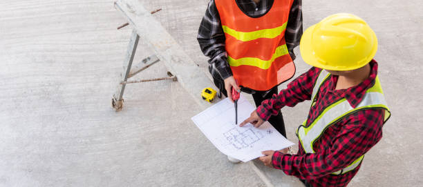 istock Architect and client discussing help create plan with blueprint of the building at construction site floor. Asian engineer foreman worker man and woman meeting and planning construction work, top view 1369040256