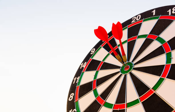 istock Dart arrow hit center on bullseye dartboard is target 1369040301